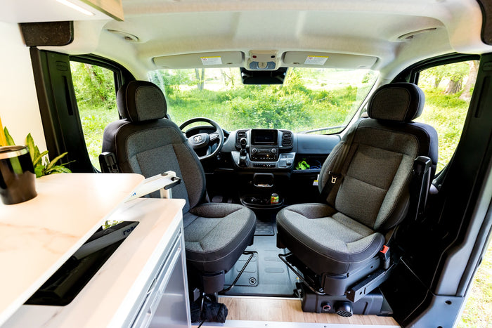 Spacious, modern campervan interior, ideal for an RV rental. Enjoy scenic views from the comfortable front seats.
