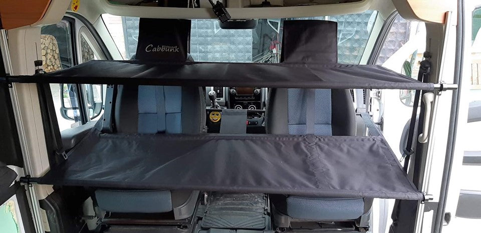 RV rental camper van interior showing Cabbunk portable bunk beds installed above front seats, an ideal extra sleeping solution.