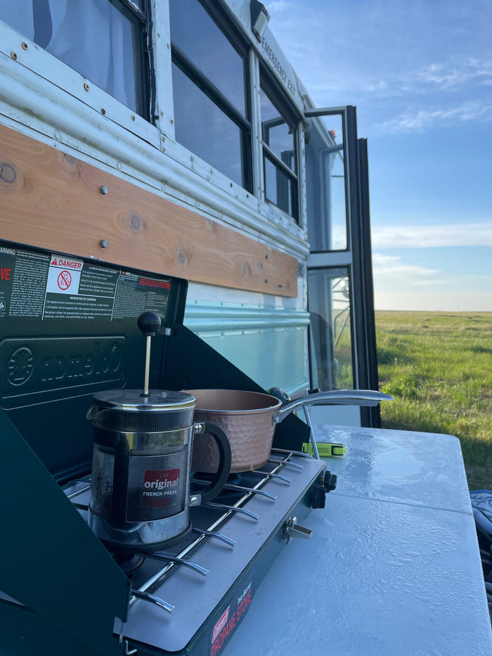 sunny prairie under blue skies.|Cozy RV rental interior with light wood walls