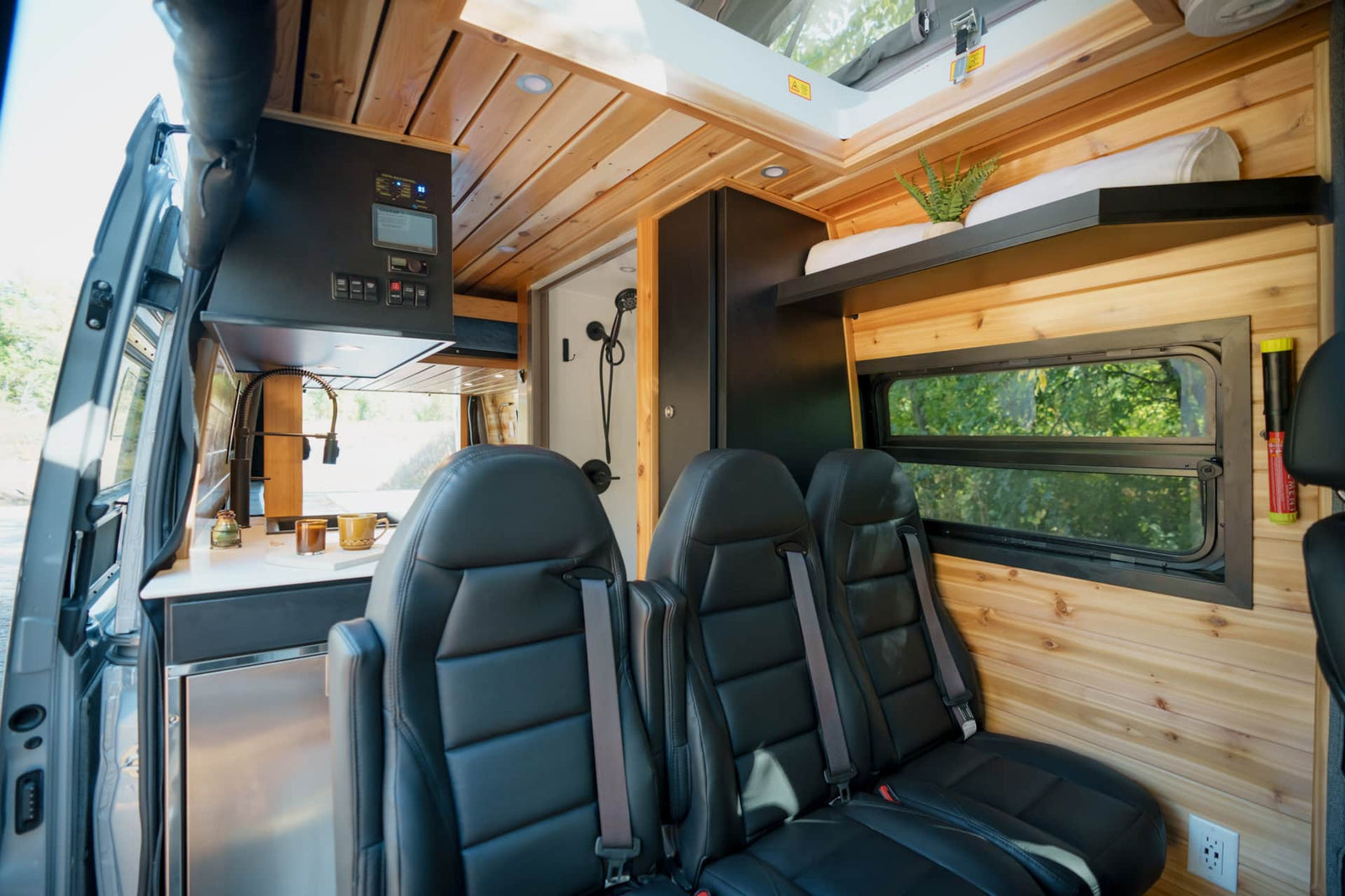 This modern RV rental showcases a bright interior with wood paneling