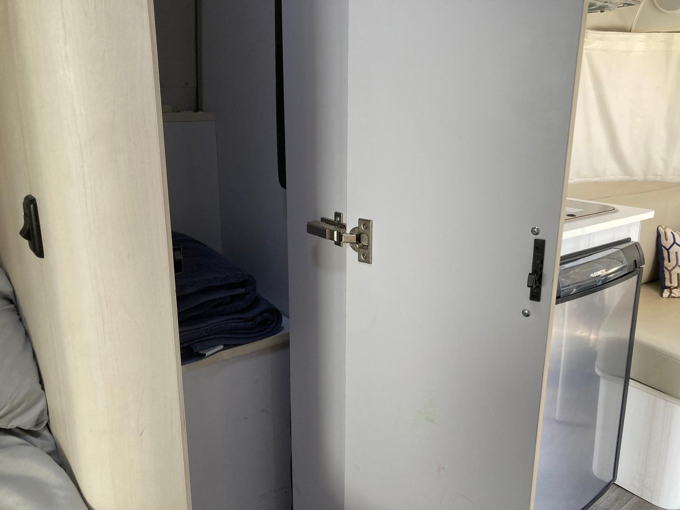 and bed.|Step inside this inviting RV rental: a compact kitchen with microwave — photo 11