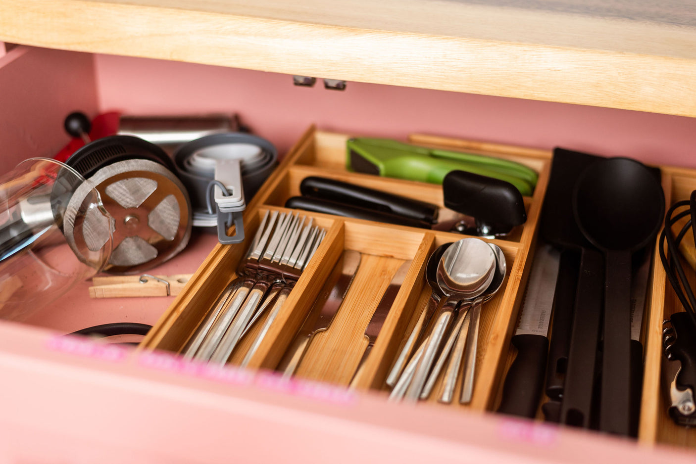 RV rental kitchen drawer: neatly organized utensils, French press, and measuring cups for your travels.