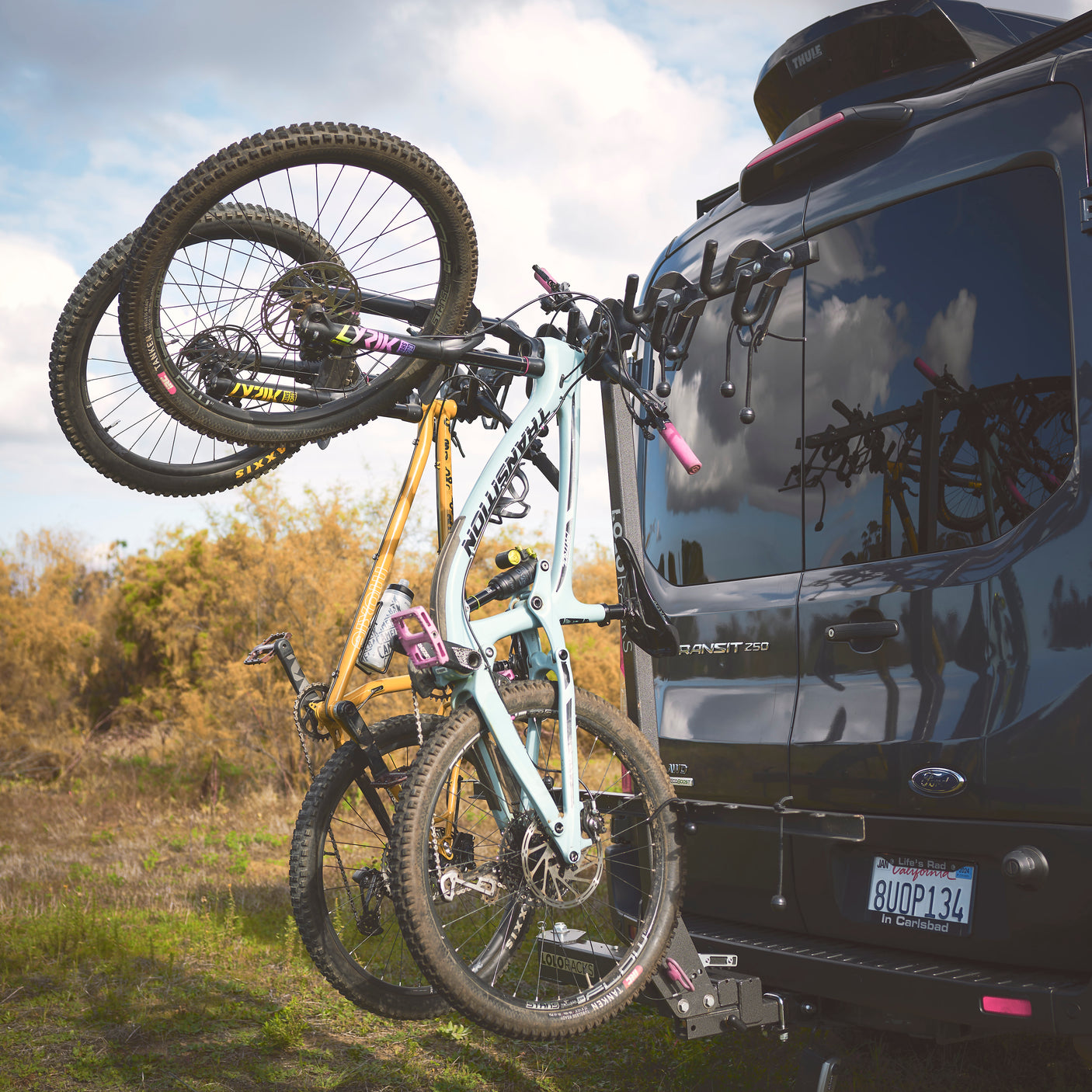 RV rental van: A Ford Transit with two mountain bikes on a rear rack, ready for outdoor adventure.