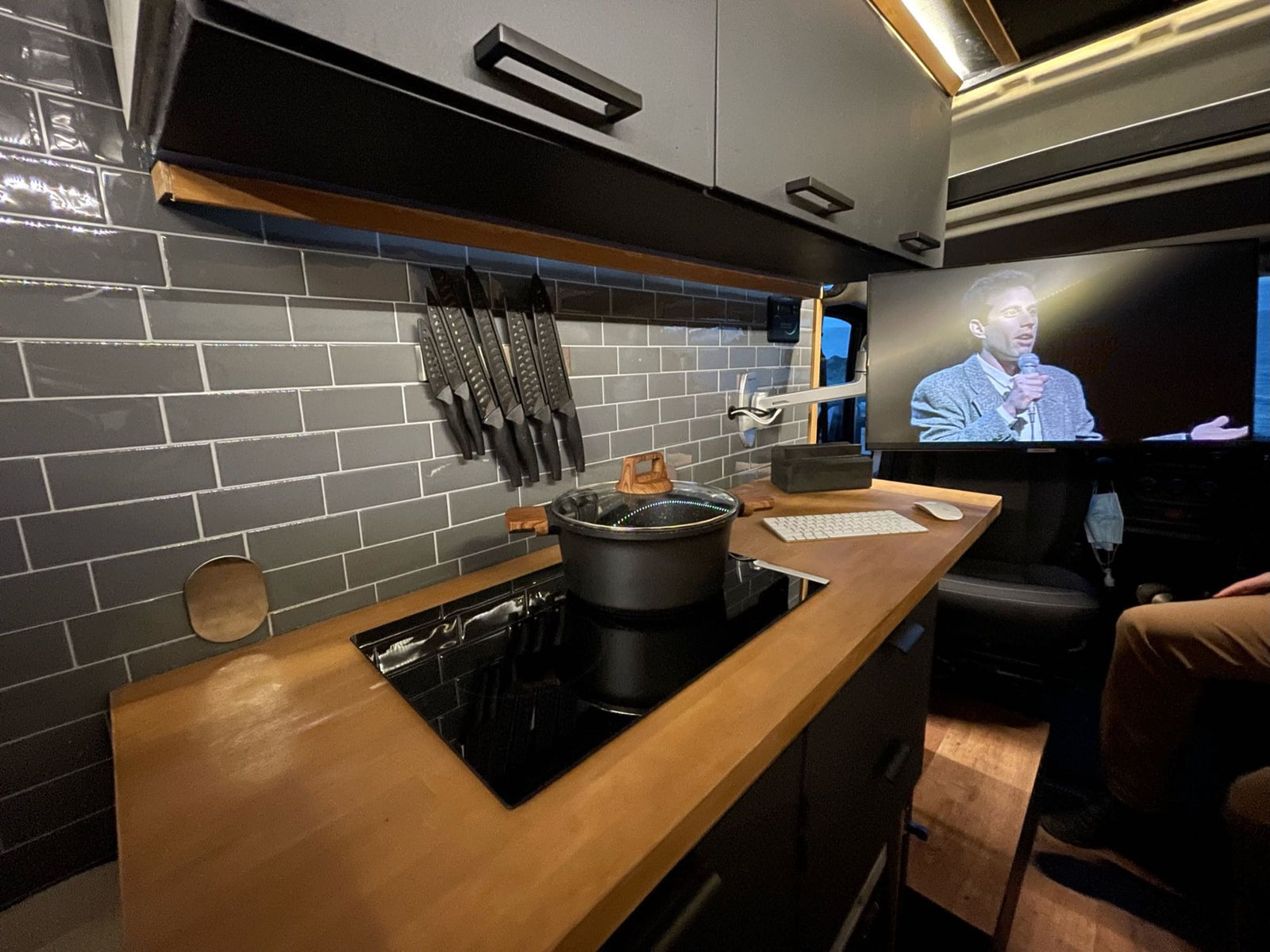 doors open to nature.|Modern RV rental kitchen with wood counters