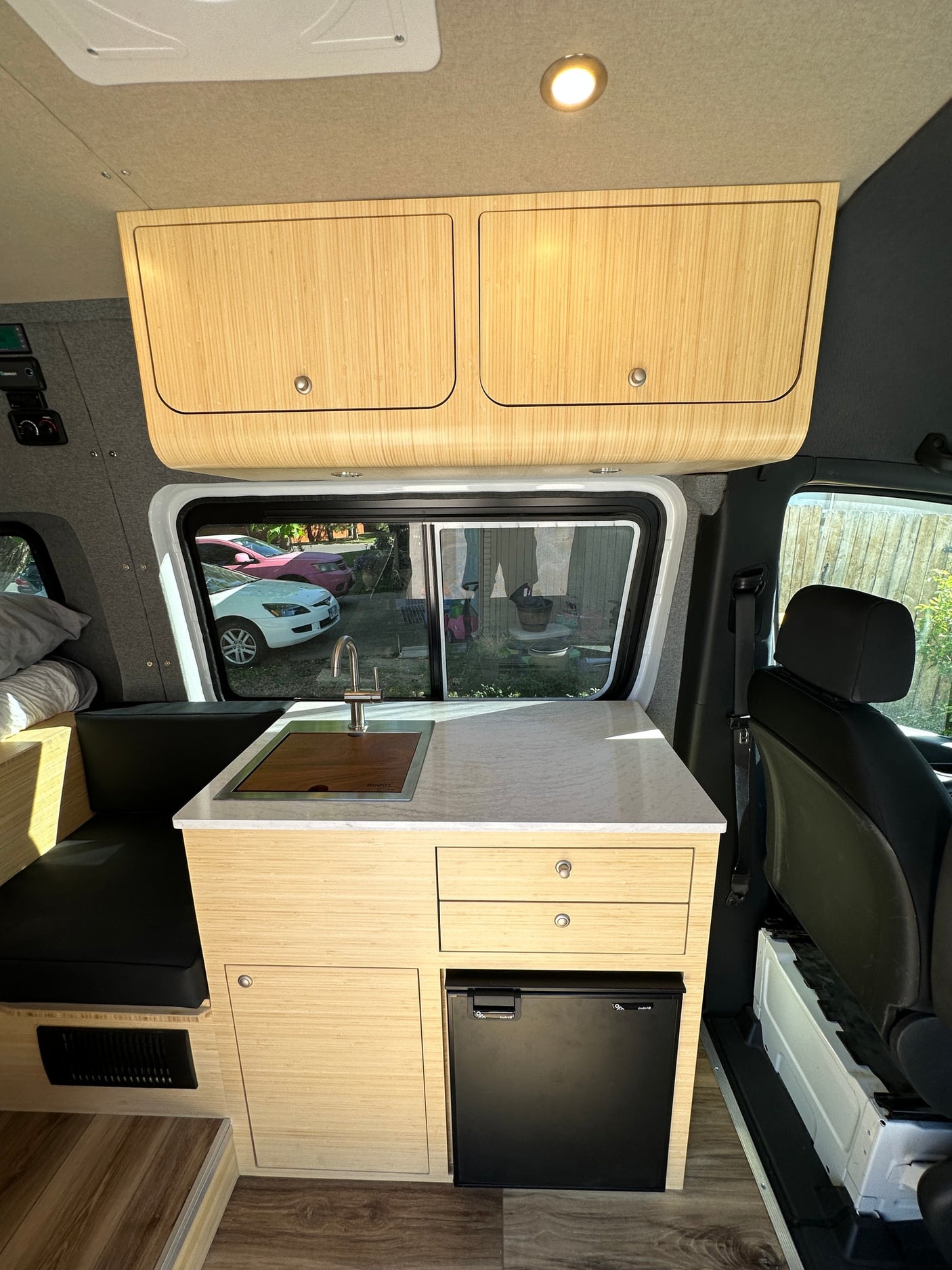 and dinette make for a functional camper van.|Interior of a modern RV rental camper van with a bed