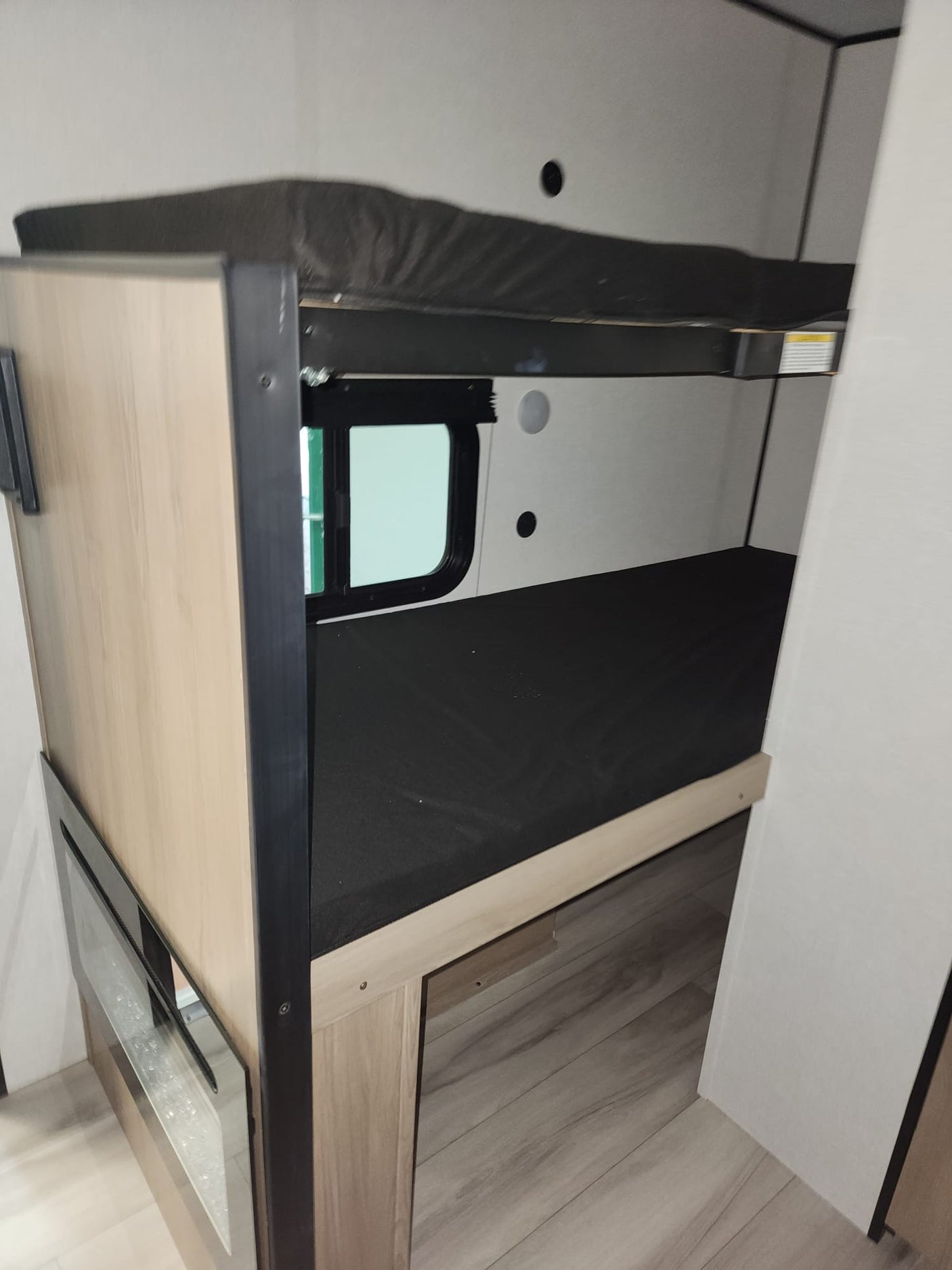 and shower.|Modern RV rental kitchenette featuring a microwave