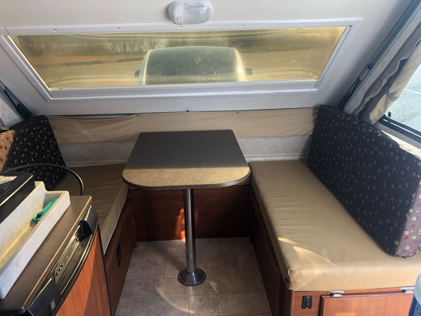 suitable for an RV rental adventure.|Cozy RV rental interior featuring a bed