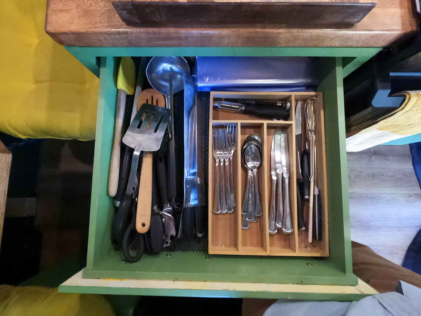 Organized kitchen drawer in an RV rental, filled with cooking utensils like spatulas, ladles, and neatly arranged silverware. — photo 13