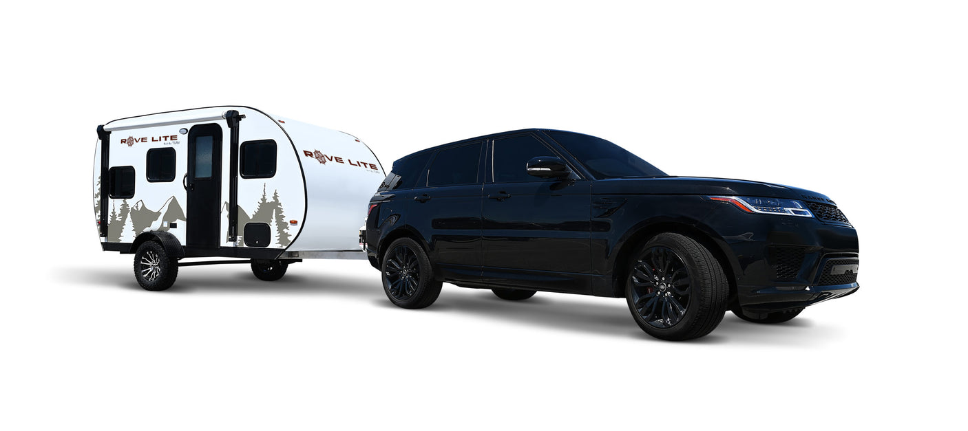 A black Range Rover SUV tows a white Rove Lite teardrop travel trailer, ideal for your next rv rental adventure.