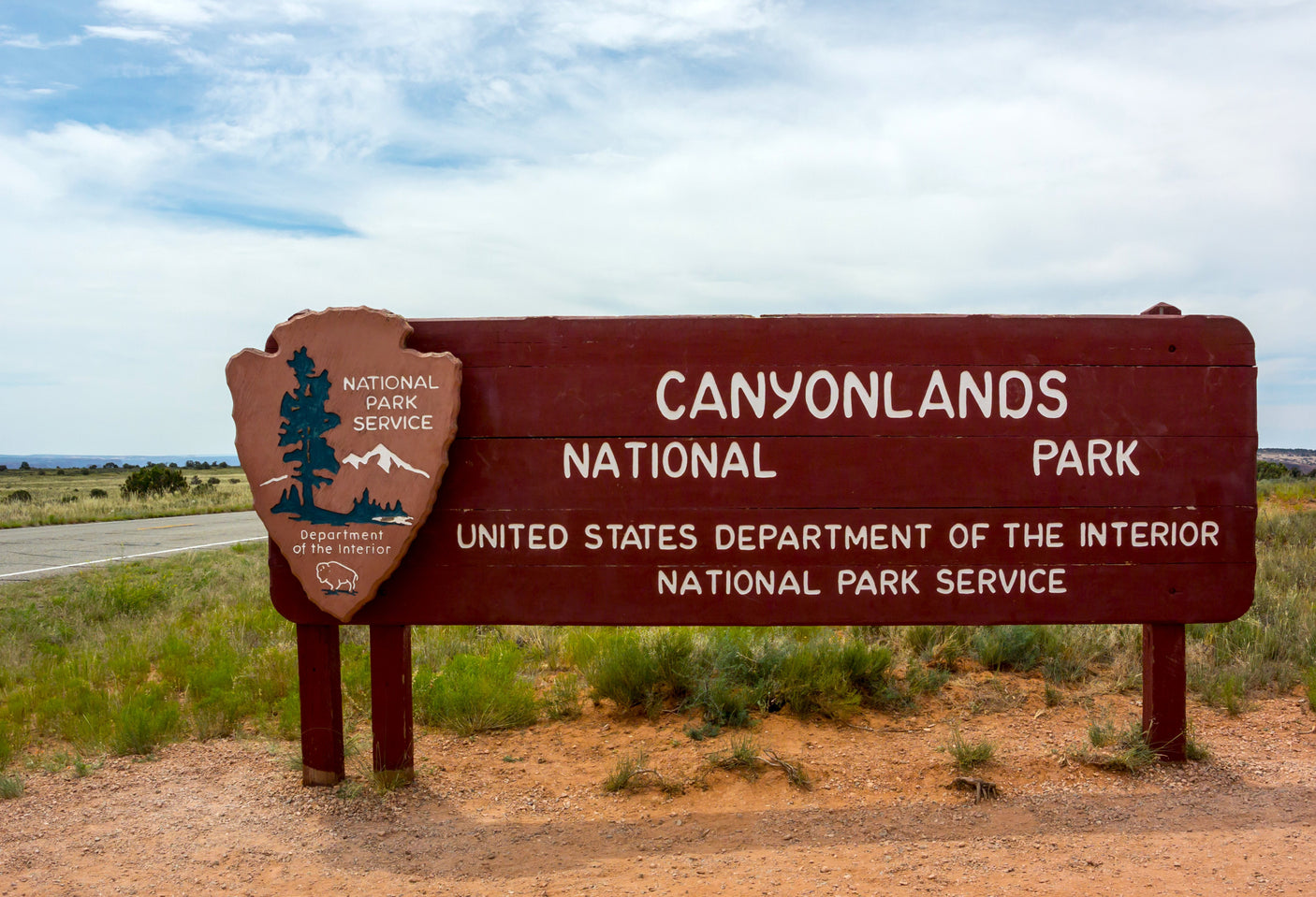 Entering Canyonlands National Park via the iconic sign. An RV rental is ideal for exploring this US National Park Service site.