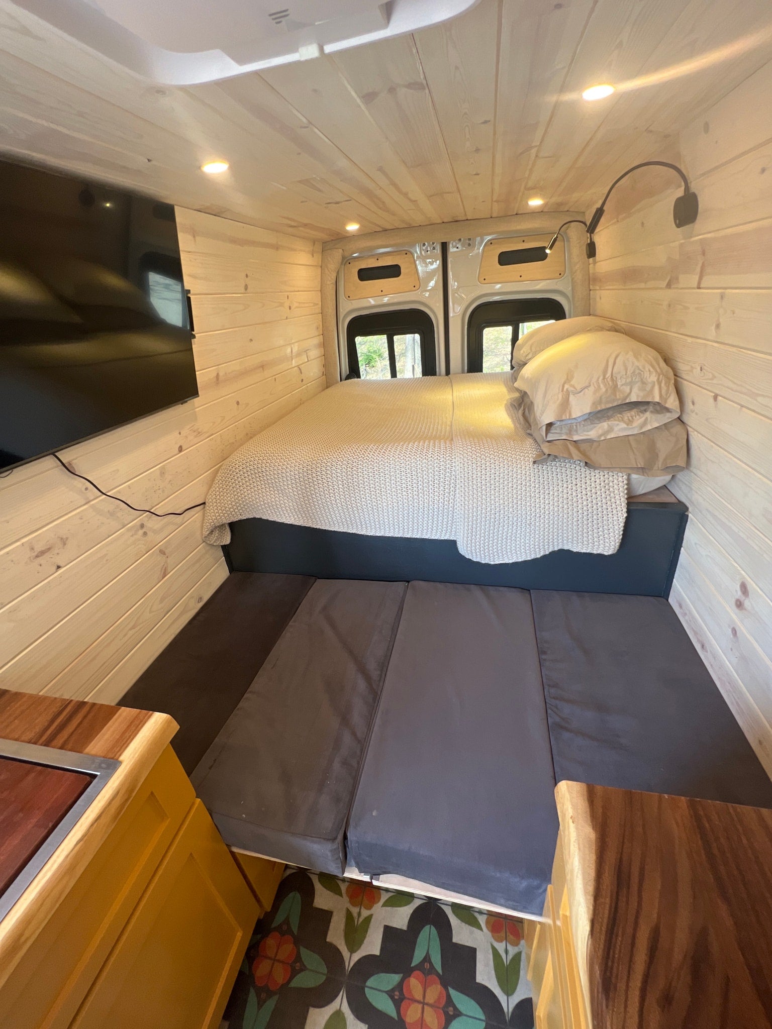 and three passenger seats.|Inside this bright rv rental: wood-paneled walls