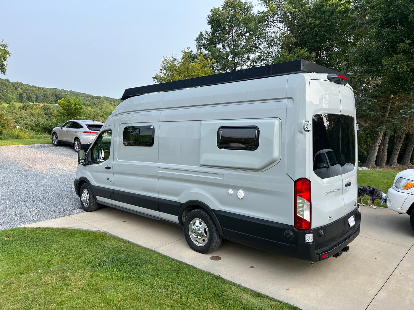 and wooden ceiling. Rear doors open to a snowy Montana view.|Step into this bright RV rental. It features a modern kitchen — photo 6