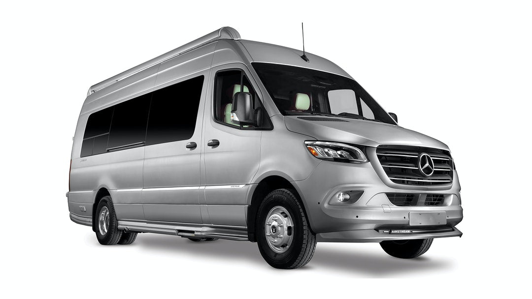 and a window with an outdoor view.|Silver Mercedes-Benz Sprinter camper van. Explore with this sleek RV rental motorhome.|Silver Mercedes-Benz Sprinter RV rental. This spacious camper van is set up for outdoor adventures.|Bright