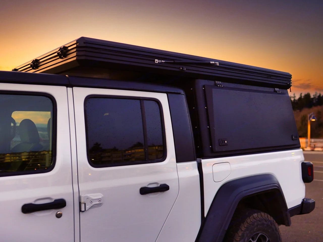 with two campers enjoying the view.|This white Jeep Gladiator pickup with an overland truck camper — photo 4