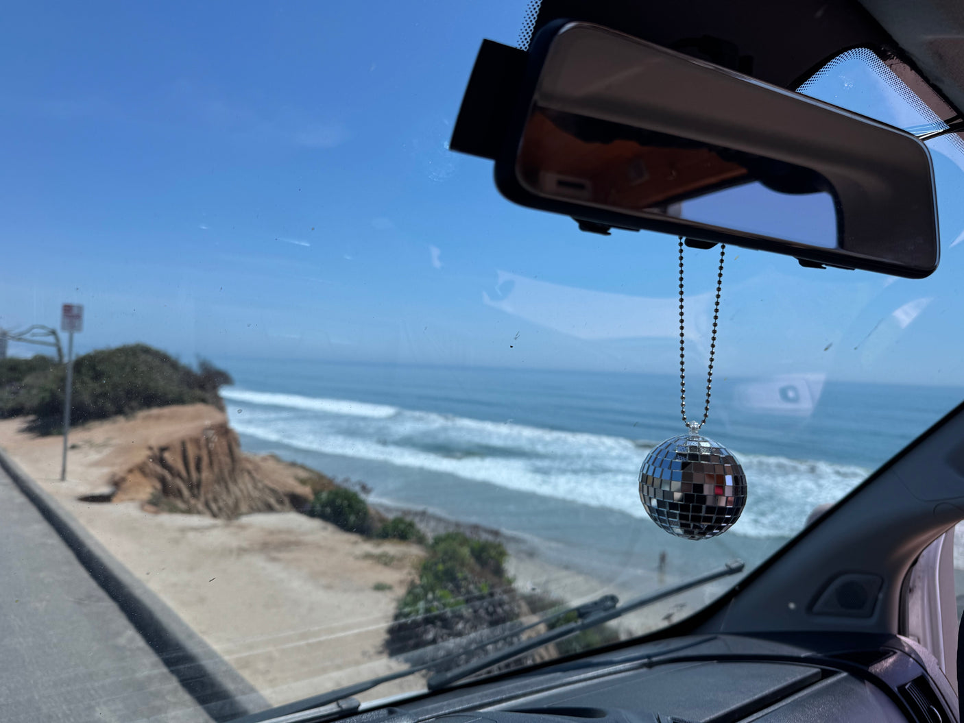 Enjoying a stunning ocean view from an RV rental, complete with a fun disco ball. Ideal for scenic road trips.