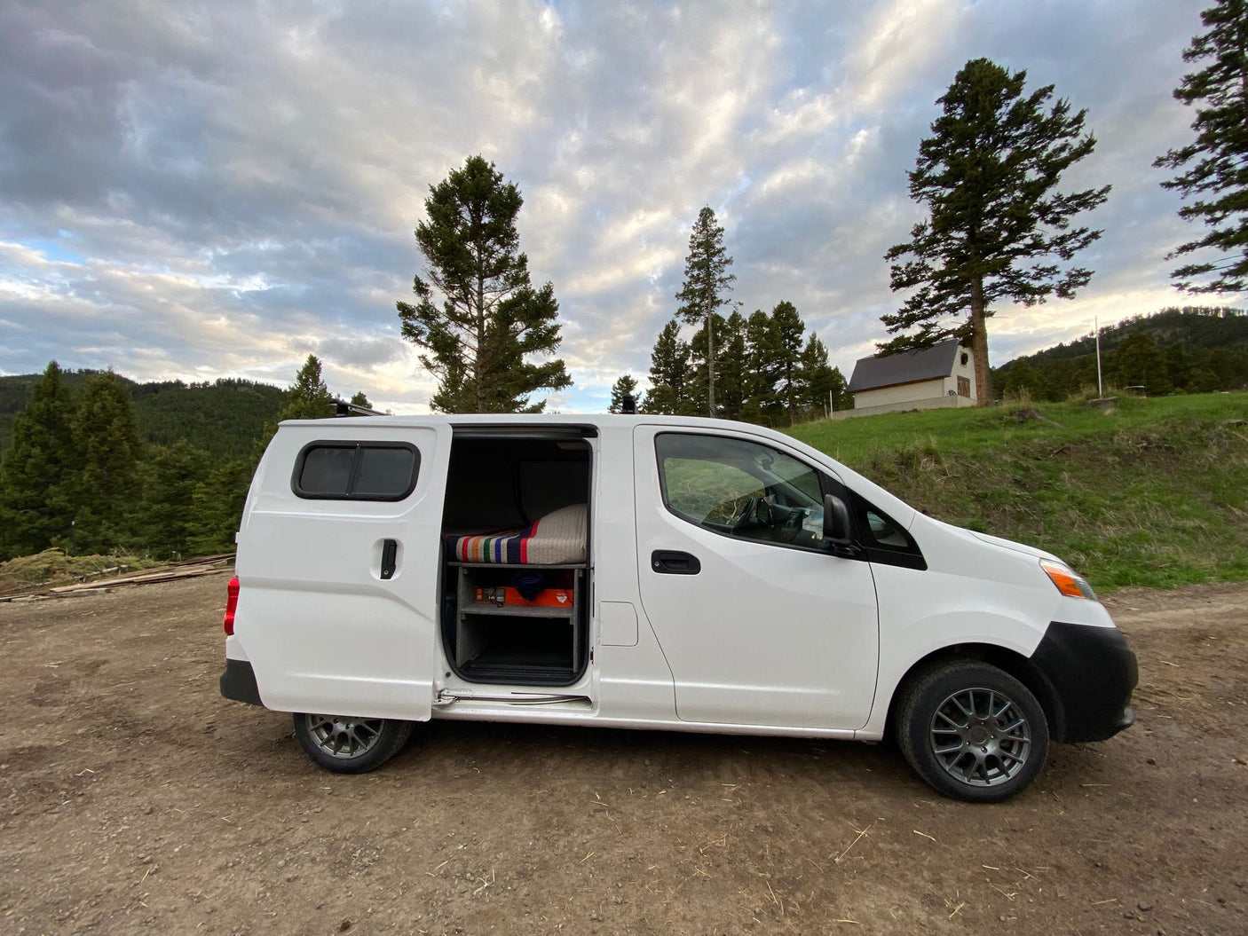 and a scenic side window view. Great for van life.|White van with paddleboards on roof by a sparkling lake