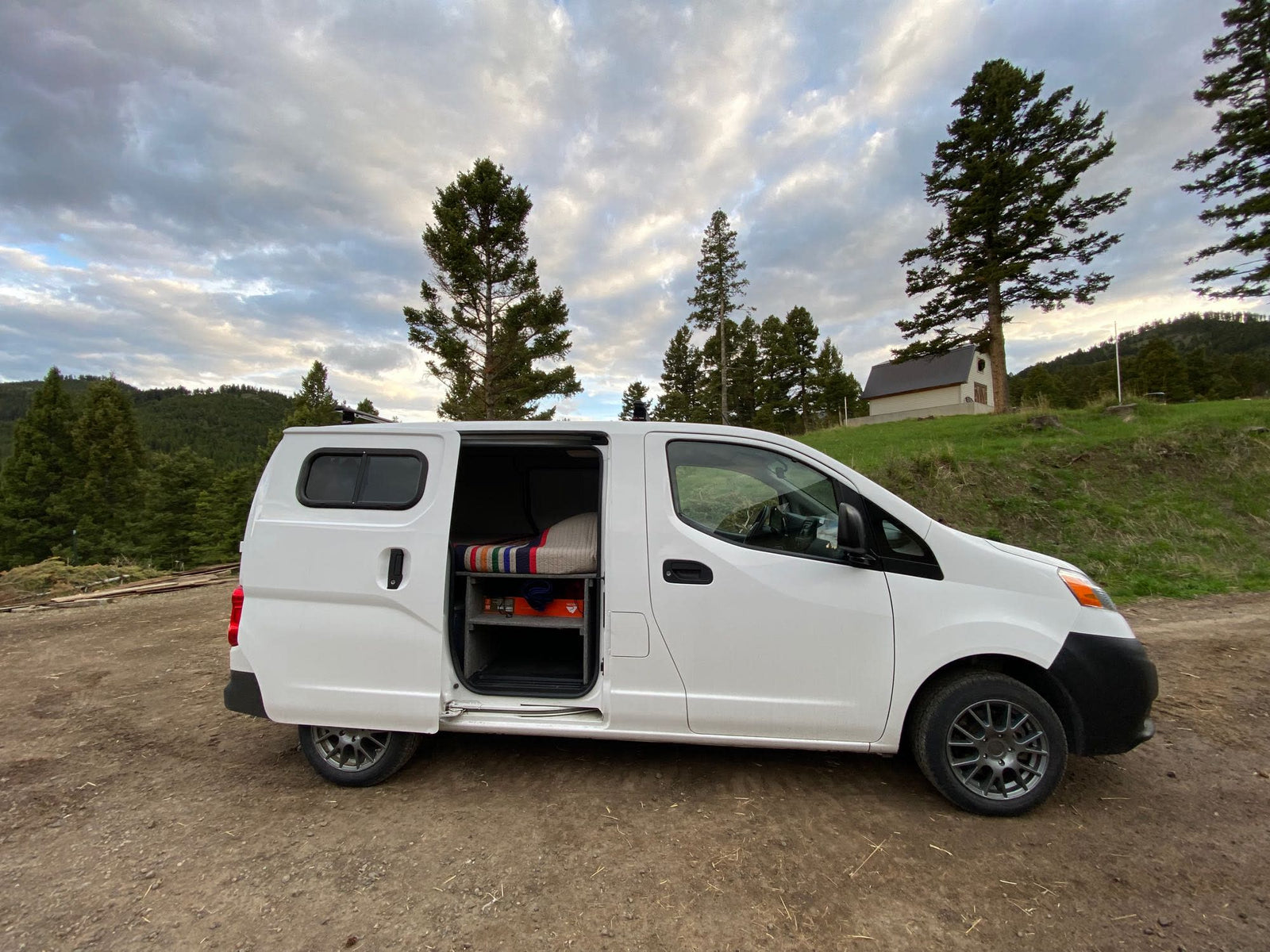 and a scenic side window view. Great for van life.|White van with paddleboards on roof by a sparkling lake
