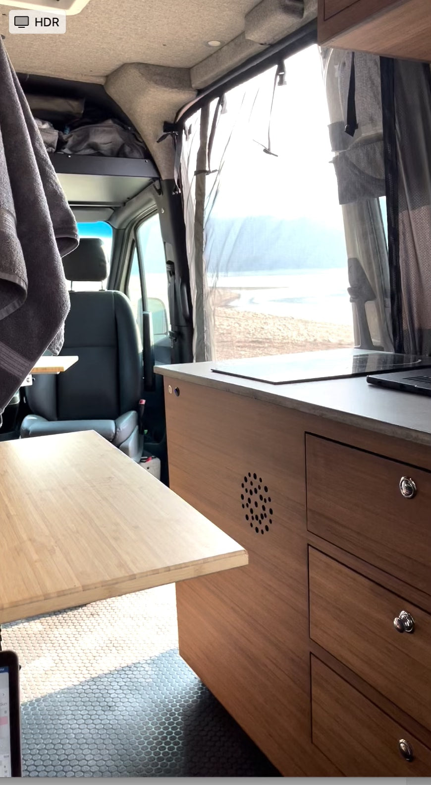 facing majestic mountains. Ready for adventure.|Interior of a spacious camper van available for RV rental