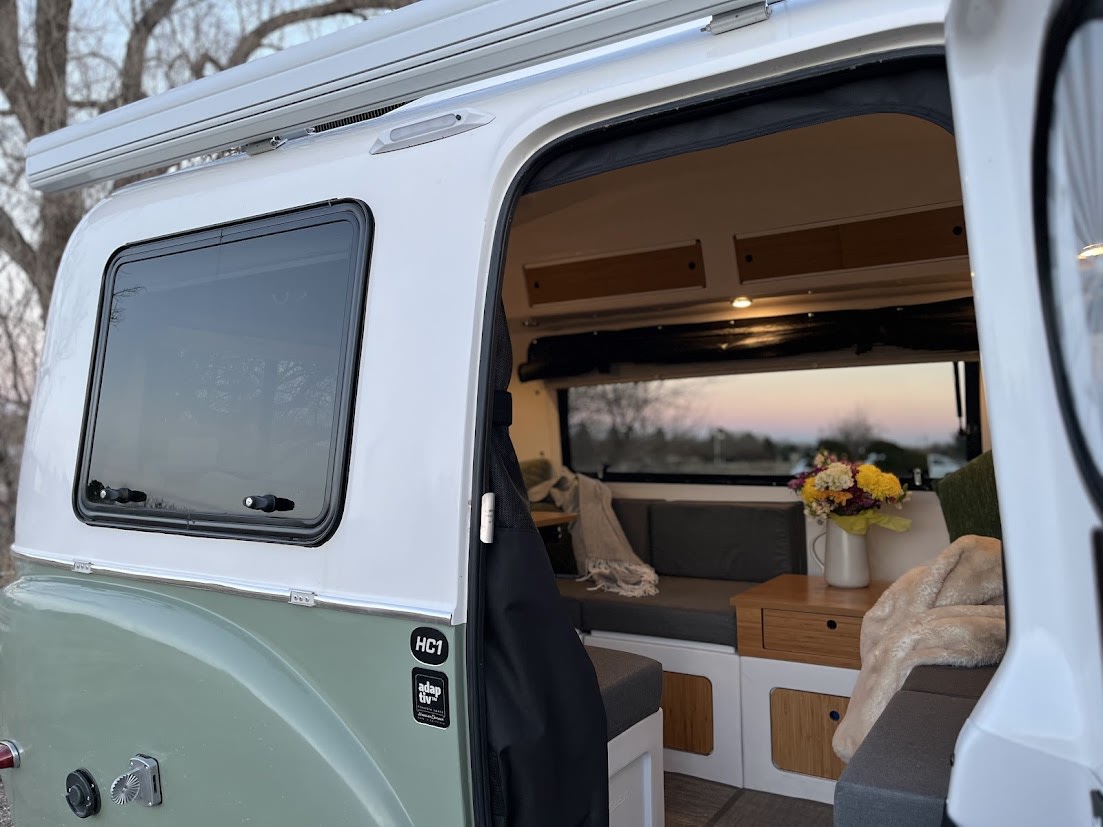 perfect for adventure.|Enjoy an RV rental adventure: a Happier Camper travel trailer overlooking the snowy Boulder Flatirons.|Explore the inviting interior of this unique rv rental