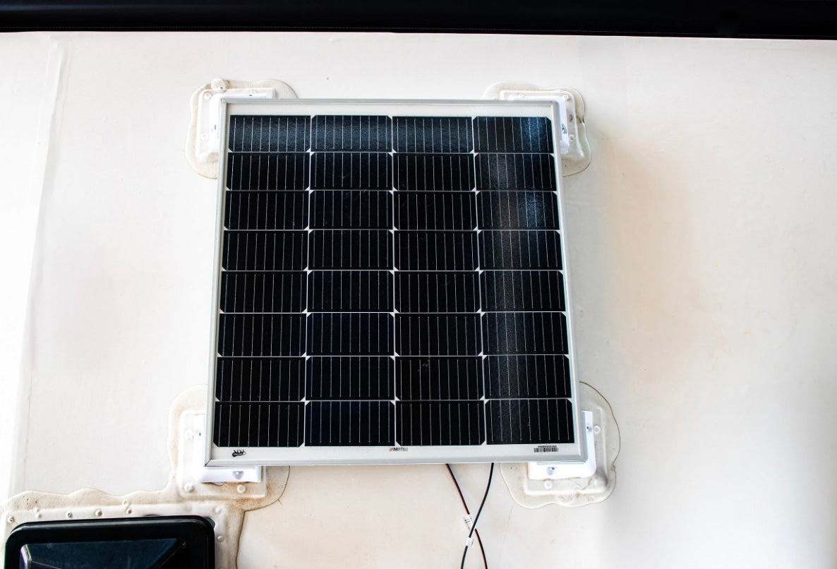 Solar panel mounted on an RV roof with sealed brackets, providing off-grid power for your rv rental adventures.