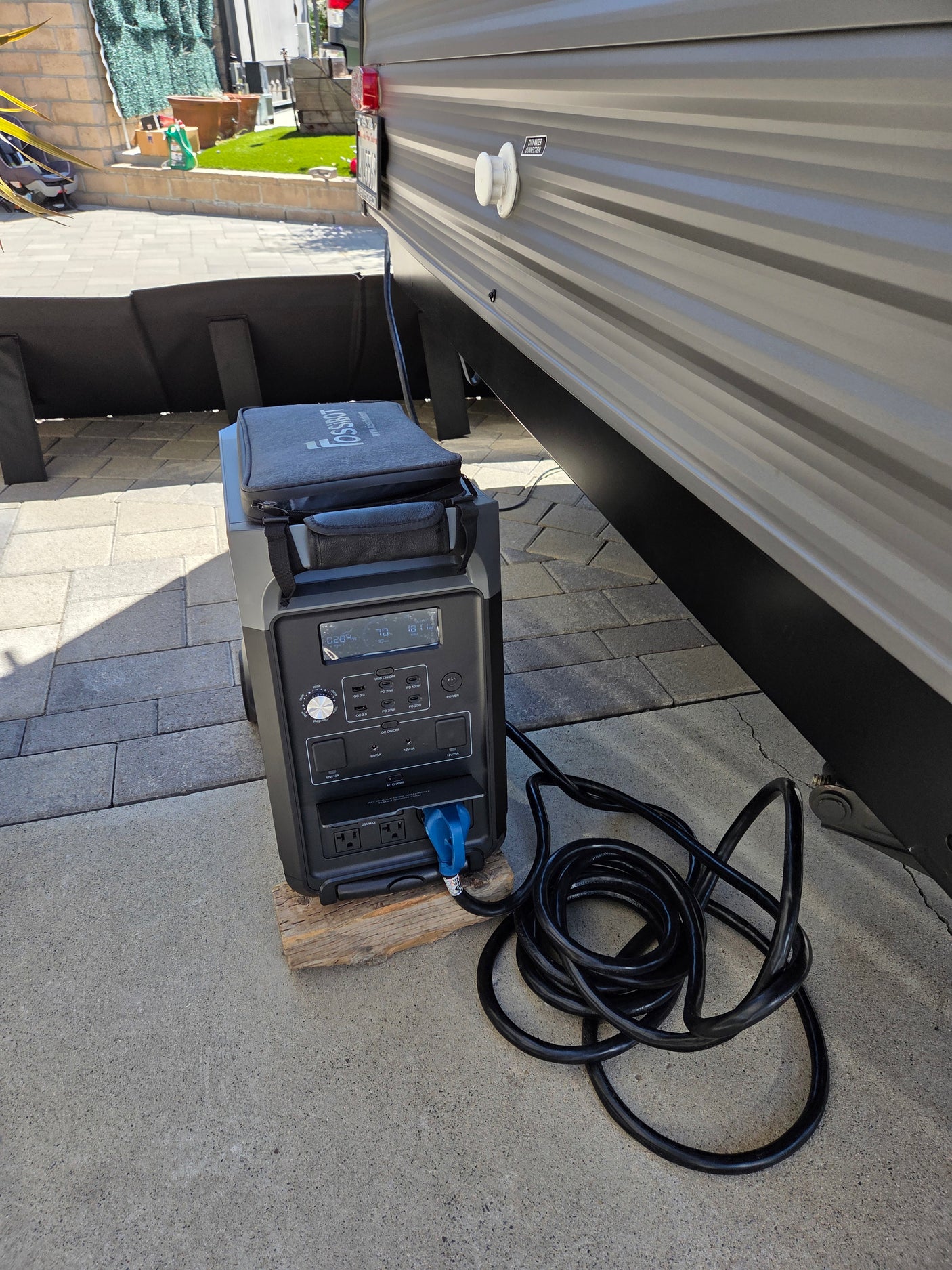 A FOSSBOT portable power station provides outdoor power for an RV rental, perfect for travel and camping needs.