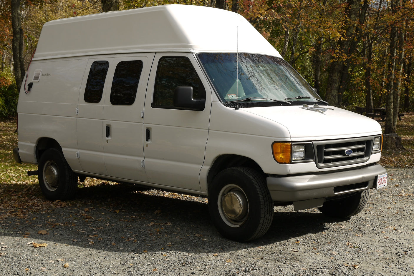 gleaming in the sun.|Chrome 'Bel Air' emblem on a light-colored RV rental