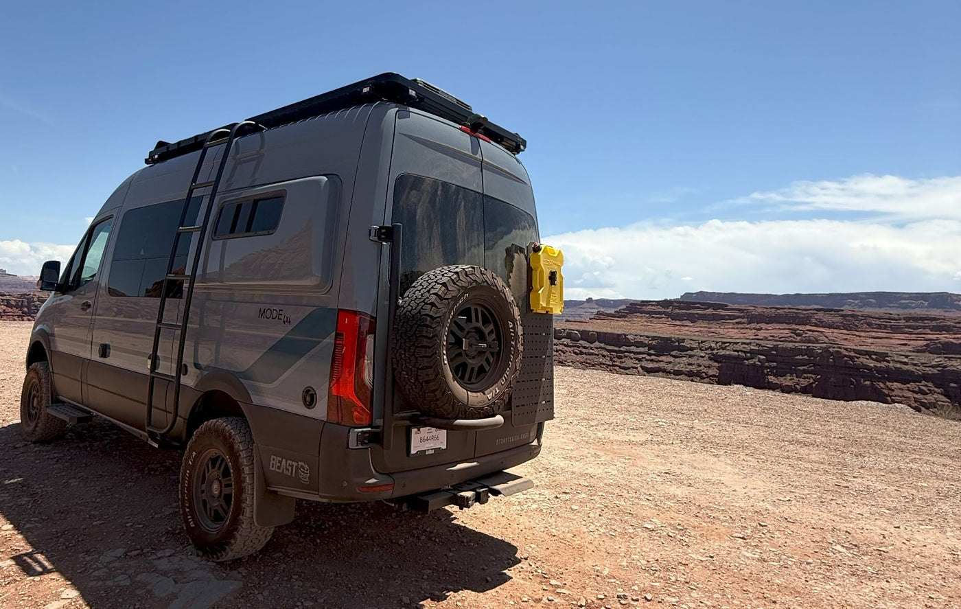 perfect for rugged canyon adventures.|Adventure-ready gray Mode 4x4 RV rental van with off-road tires — photo 4