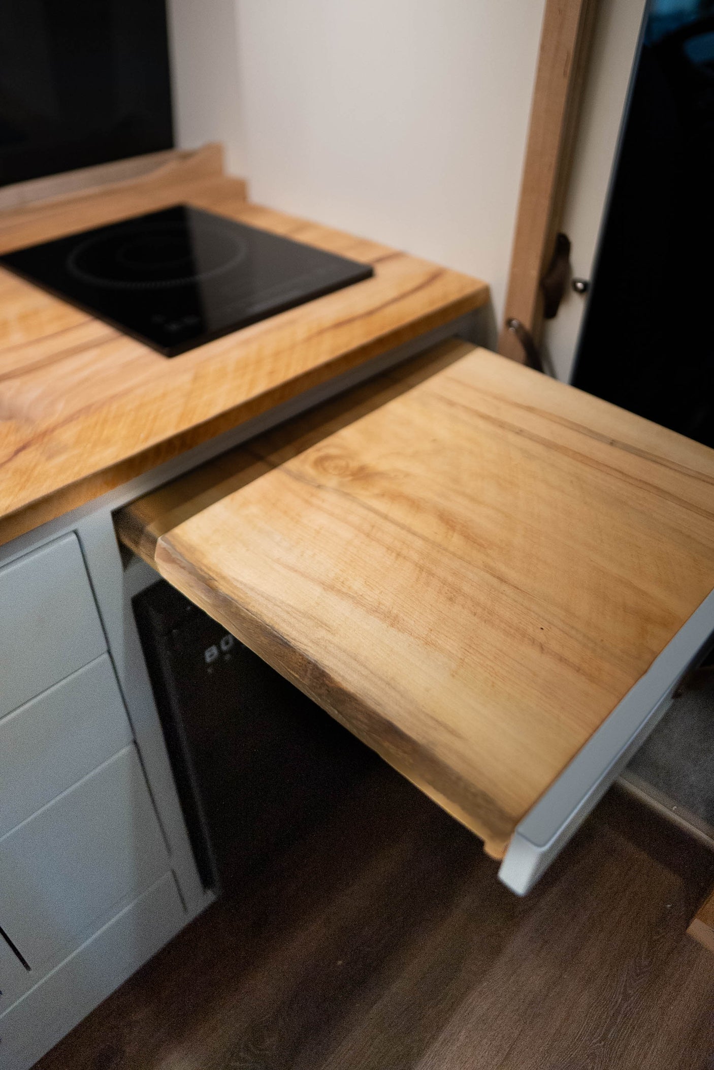 and beautiful wood counter.|Modern RV rental kitchen featuring wood ceilings