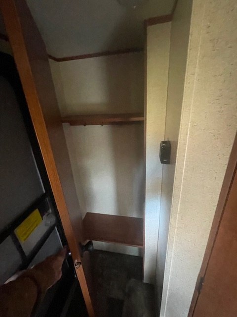 with trees visible outside.|Inside an RV rental: cozy living space with brown seating