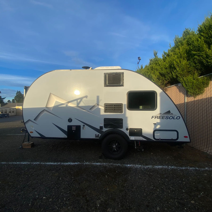 and textured walls.|Cozy RV rental interior: featuring a compact kitchen