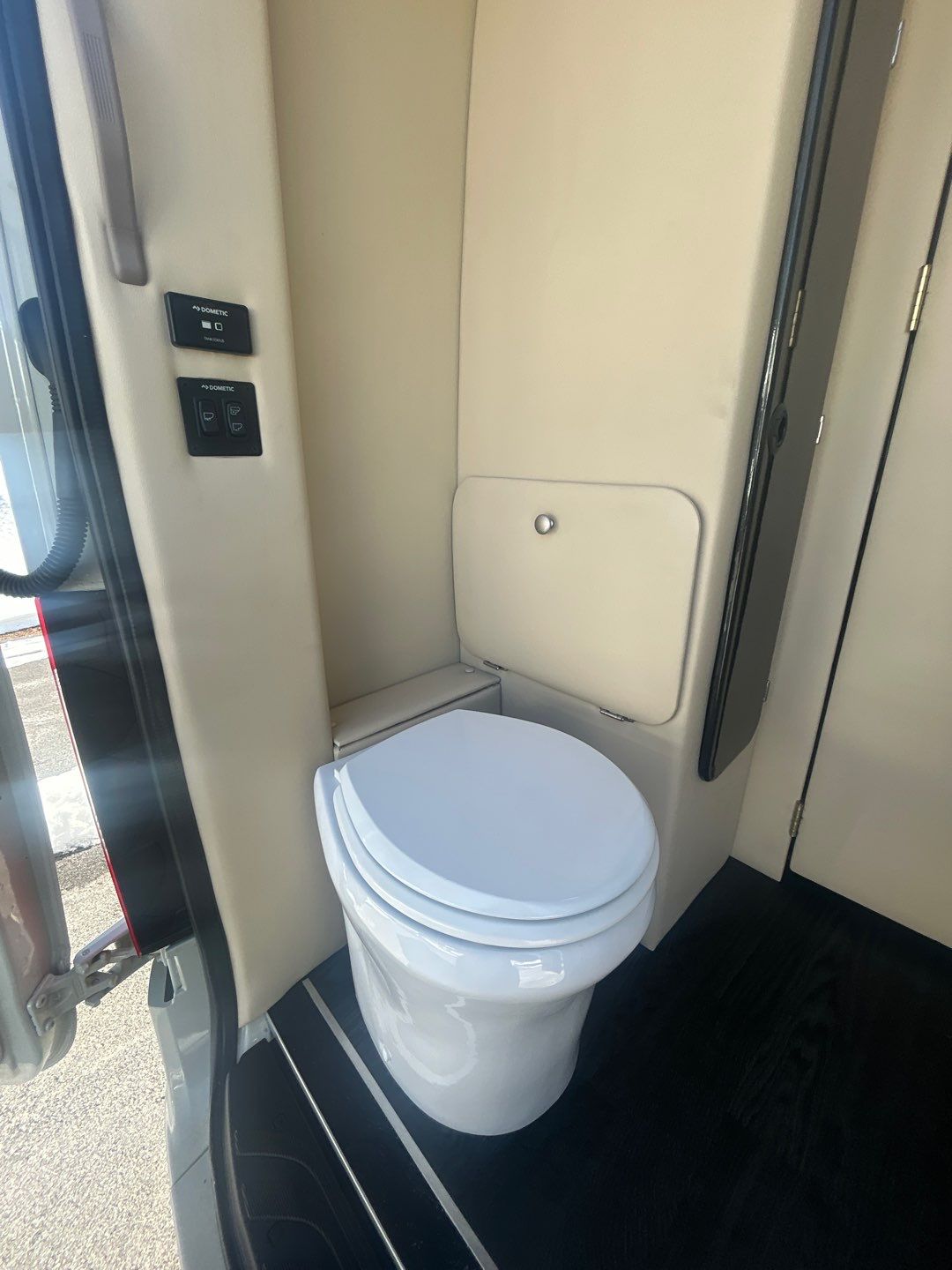 and dark flooring for a premium travel experience.|Luxury quilted leather passenger seat in an rv rental