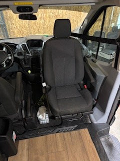 RV rental van interior: front seats, dashboard, and wood-look floor of a converted campervan. Ready for your adventure!
