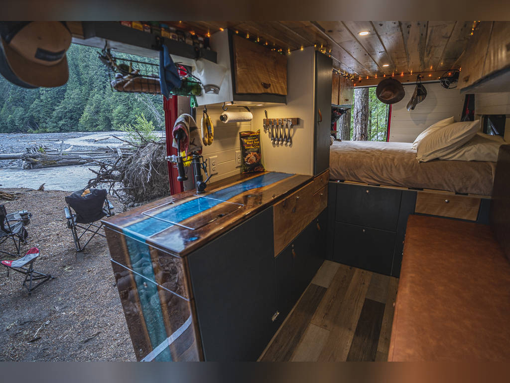 and distant mountains.|Cozy RV rental interior: wooden overhead cabinets
