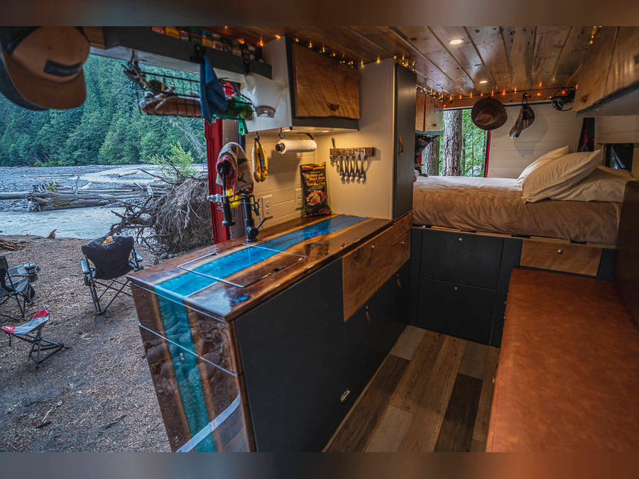 and distant mountains.|Cozy RV rental interior: wooden overhead cabinets