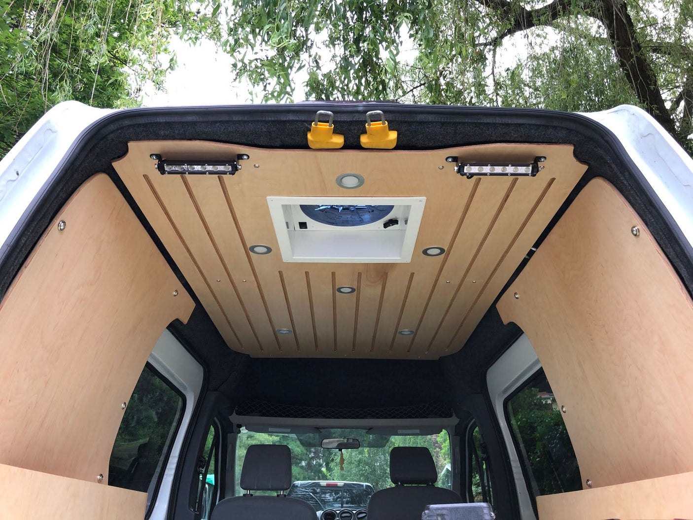 providing off-grid power for camper adventures.|RV rental van conversion with custom wooden bed frame