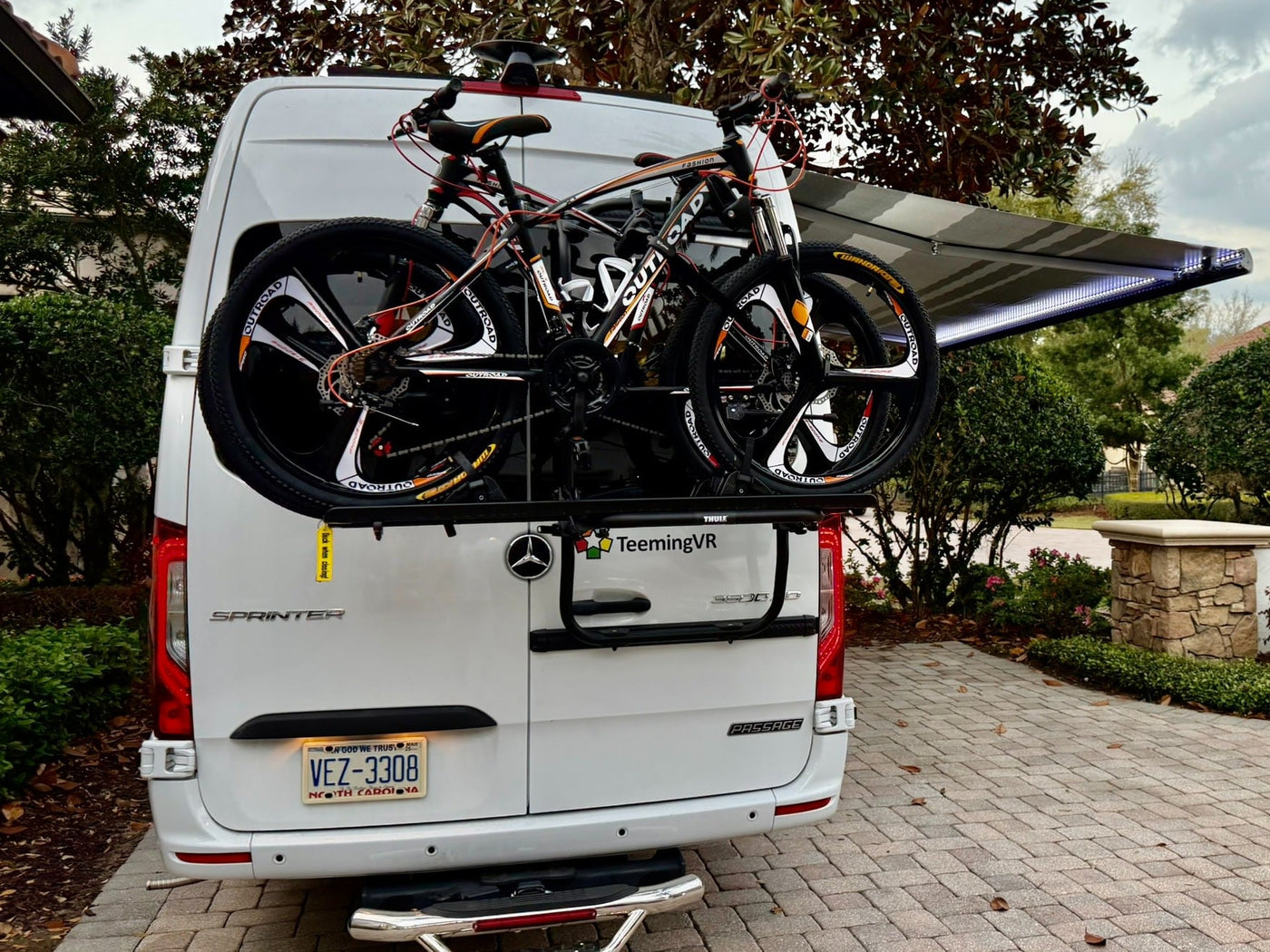 ready for adventure with bikes and extended awning.|White camper van with extended awning — photo 4