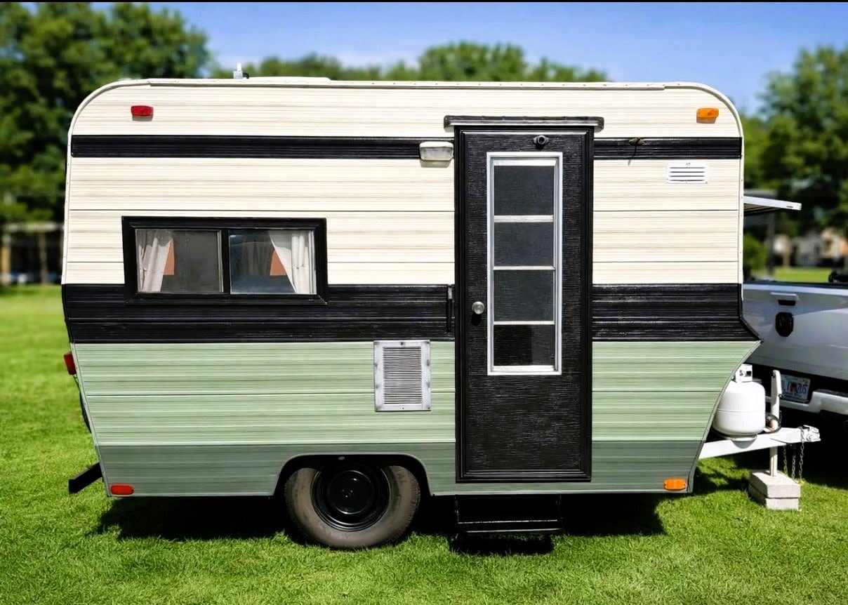 tropical-themed RV rental bathroom with a portable toilet
