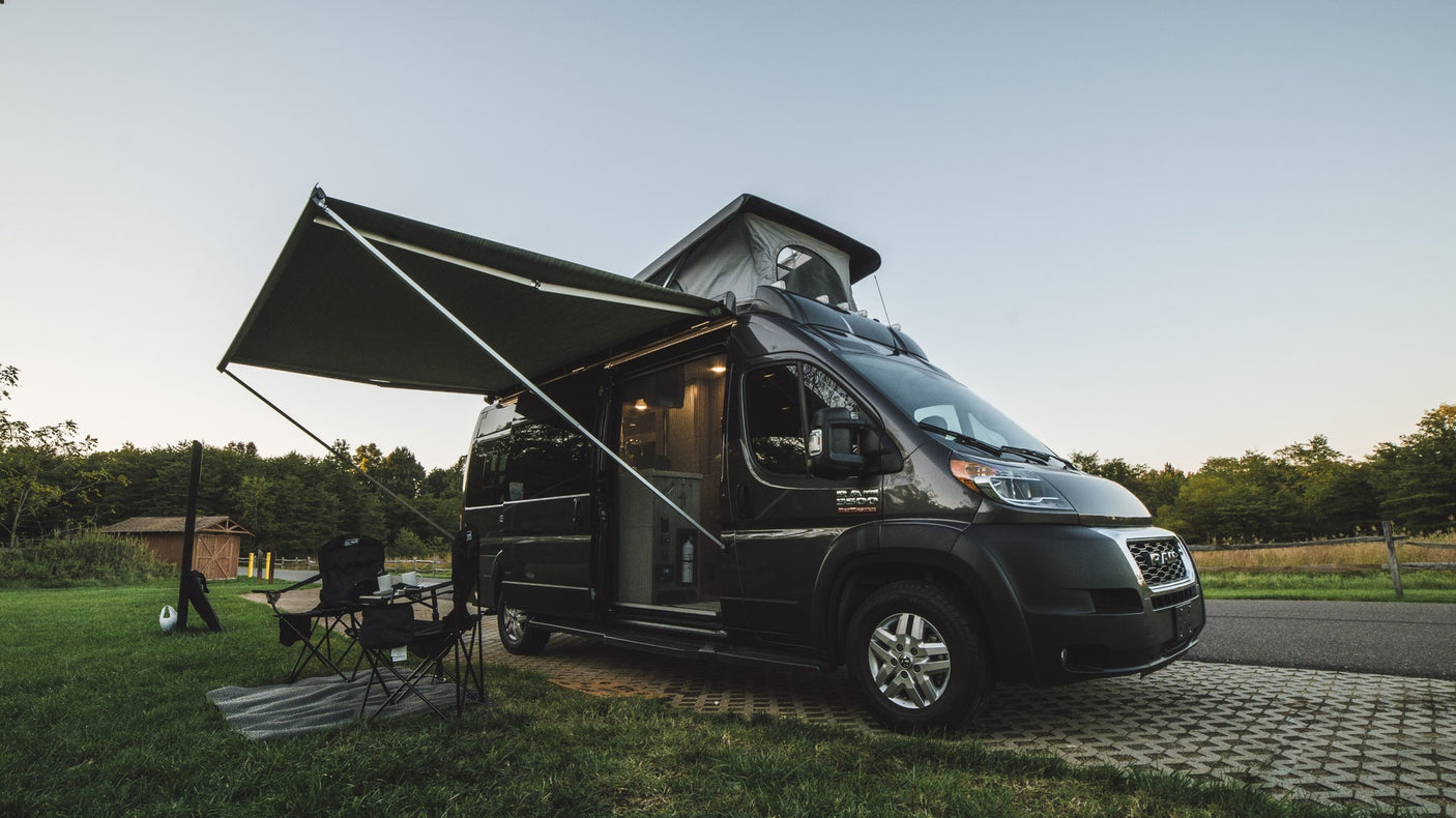 This RV rental camper van is set up for a relaxing campsite adventure