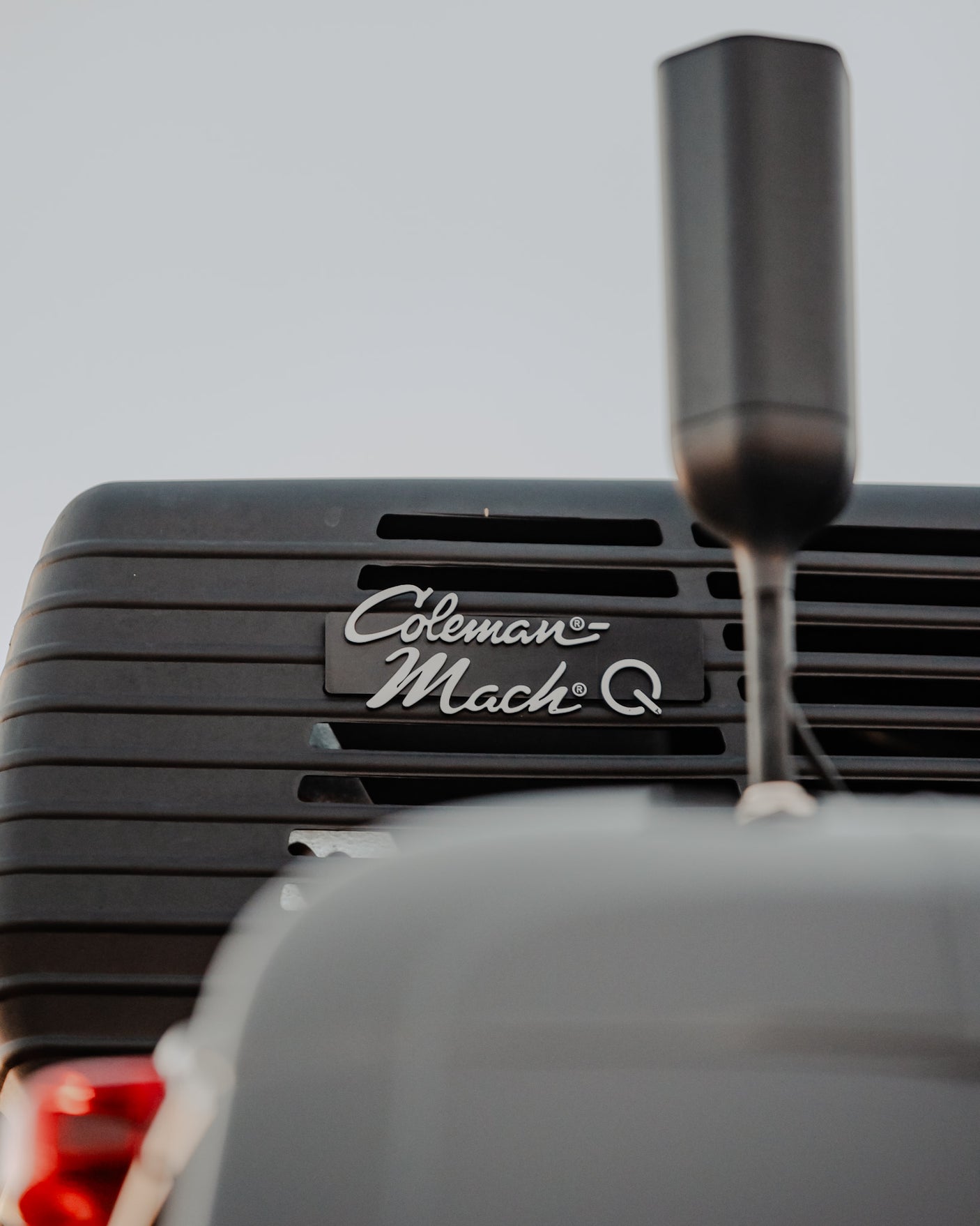 Close-up on a dark Coleman Mach Q RV air conditioner unit, mounted on a vehicle, essential for comfortable RV rental.