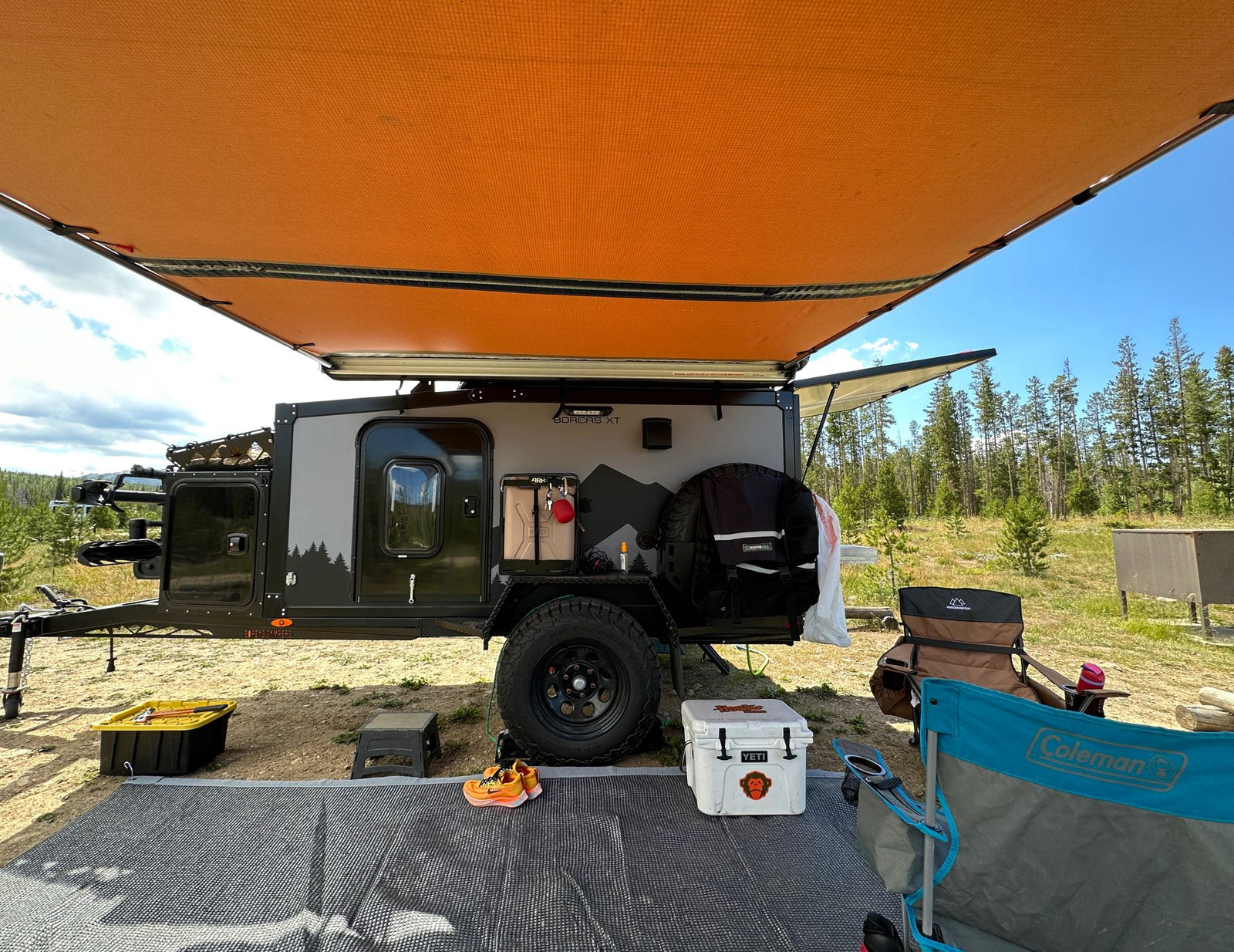 and storage—perfect for rv rental adventures.|Close-up of an RV rental's robust off-road tire and red suspension