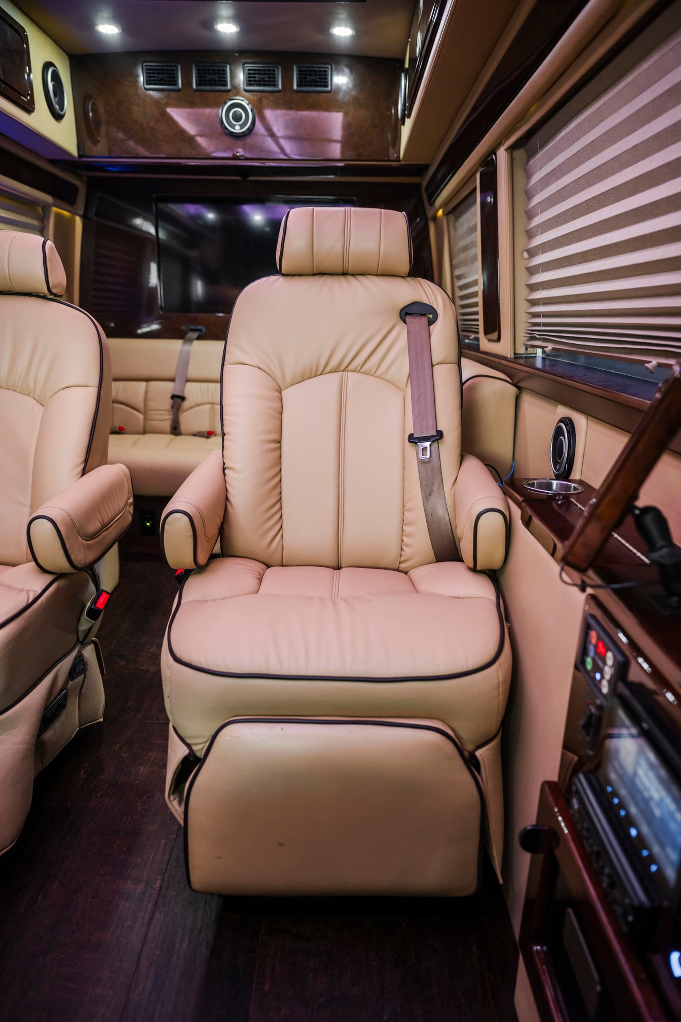 and modern amenities.|Luxury RV rental interior featuring beige leather seating — photo 15