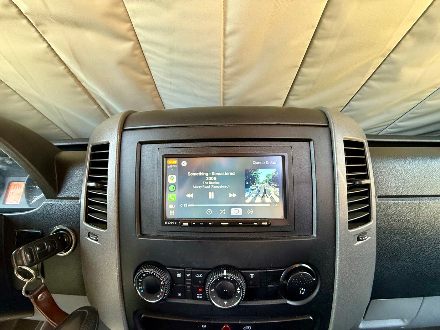 rv rental dashboard featuring a Sony infotainment system with Apple CarPlay playing The Beatles. Odometer: 198,667 miles.