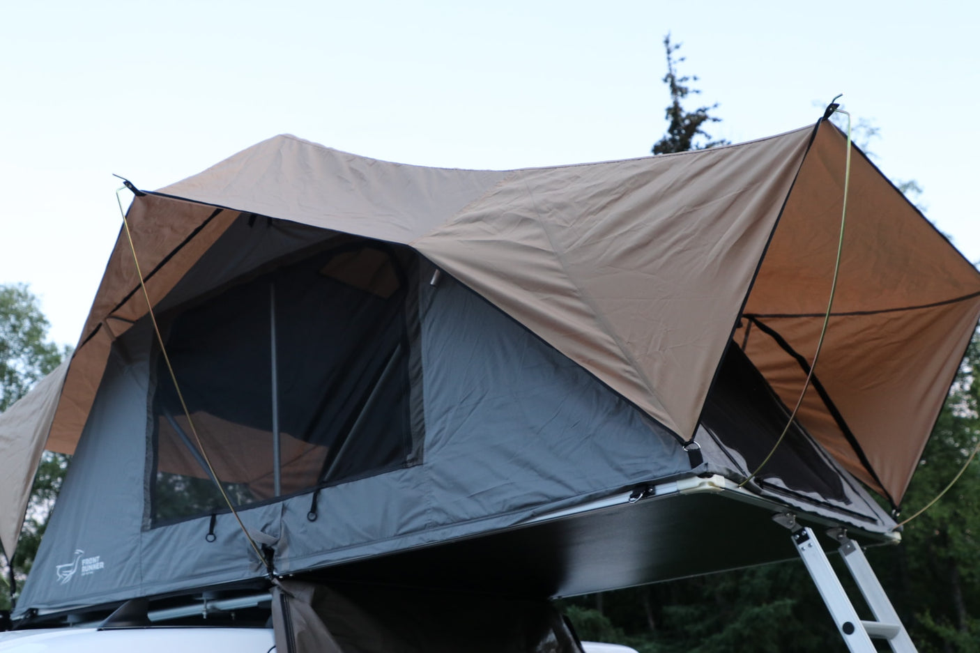 Rooftop tent for adventure camping, accessible via a ladder. Ideal for an RV rental trip or outdoor gear.