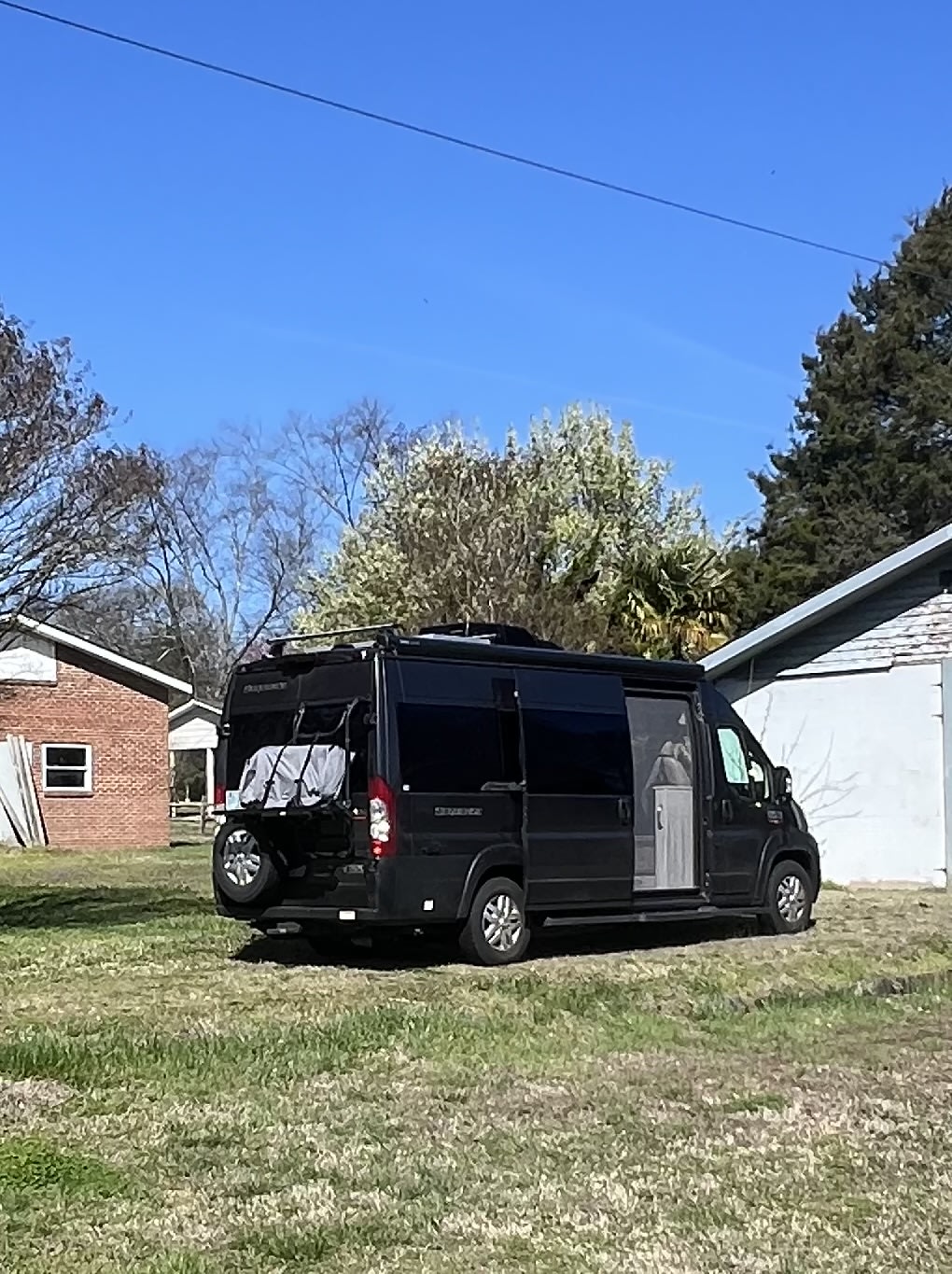 sliding door leads to front cockpit & seating.|Inside an RV rental: a compact wet bath featuring a toilet