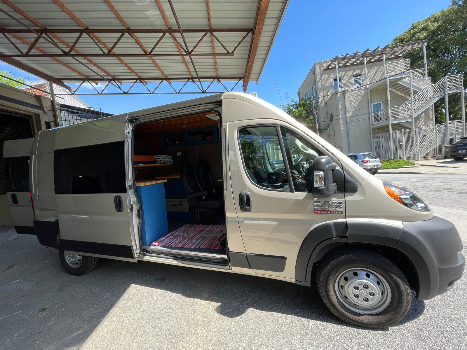 Open side door of a custom Ram ProMaster RV rental