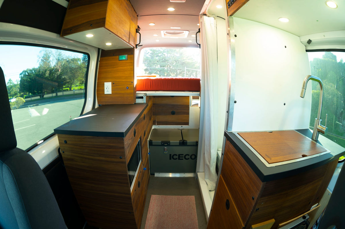 perfect for cycling enthusiasts.|A stylish custom rv rental van interior featuring a kitchenette — photo 5