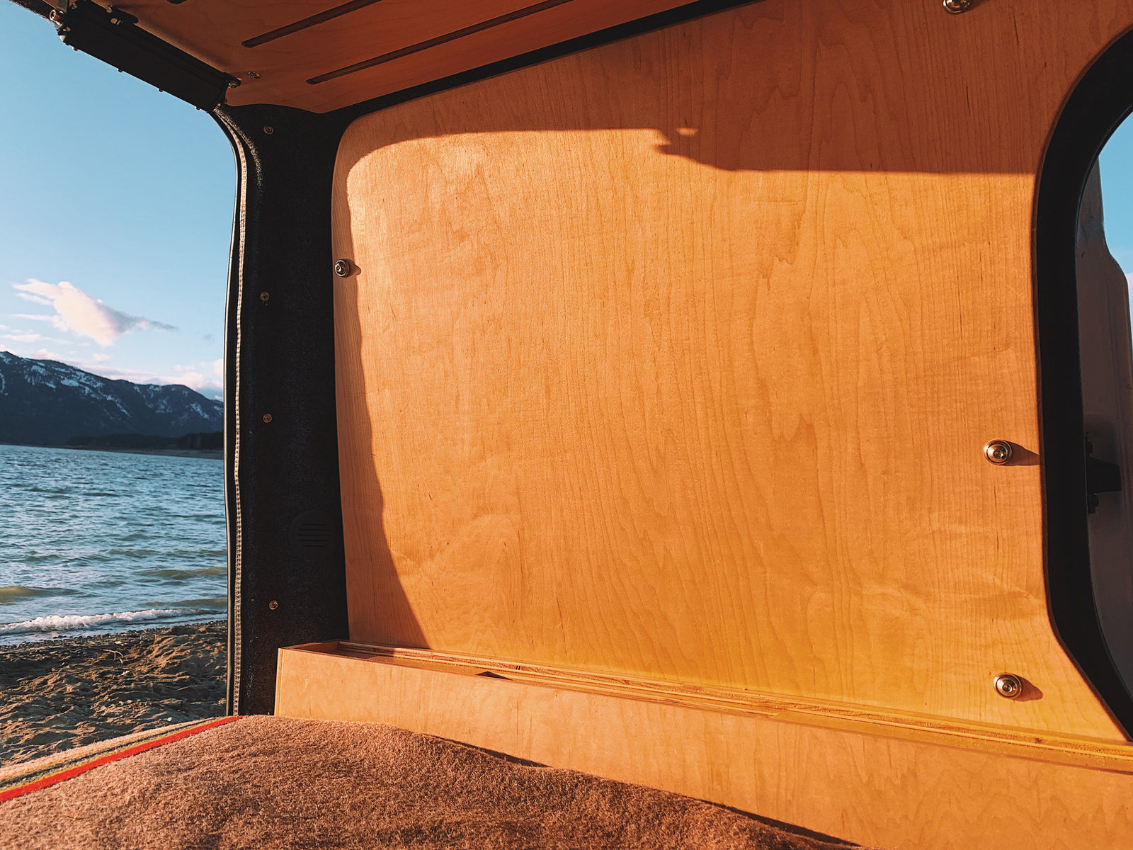 with a sunny marina outside.|Cozy RV rental interior with Govee remote