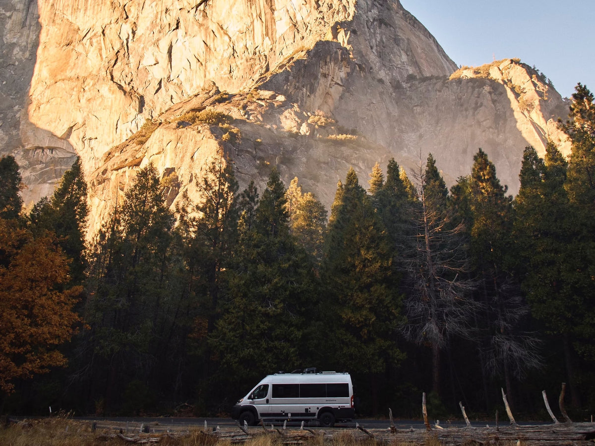 snow-capped mountains.|RV rental van on a winding desert dirt road with mountains under a blue sky — photo 4