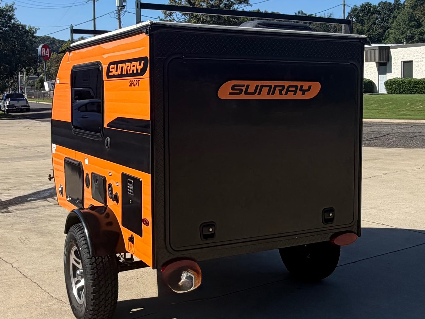 and two propane tanks.|Black teardrop RV rental with attached & portable solar panels — photo 8