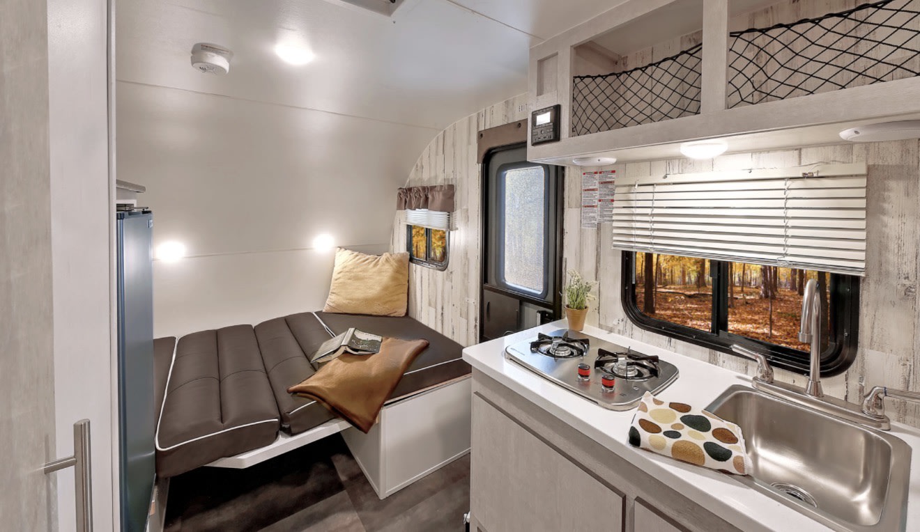 Cozy RV rental interior with a compact kitchen